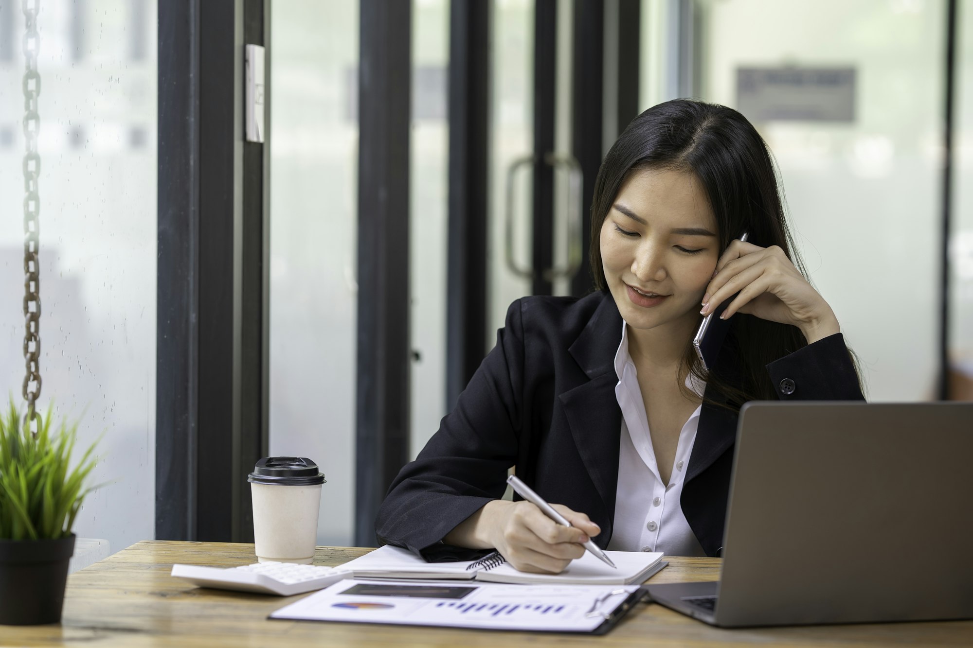 Accountant woman happy working in new office, business woman talking on the phone to agree a busines